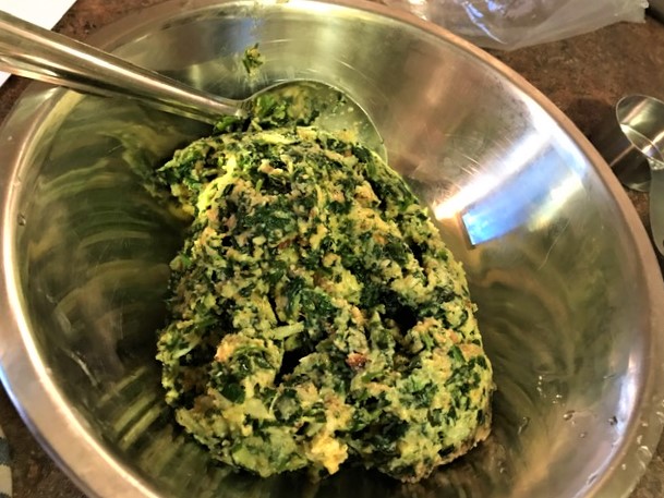 Spinach mixture with spinach, seasonings, eggs, butter and stuffing mix.  Ready to be made into spinach balls.