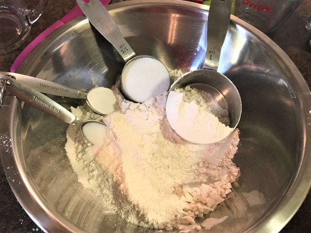 Dry ingredients for the scones - flour, sugar, baking powder and salt ready to be combined in bowl