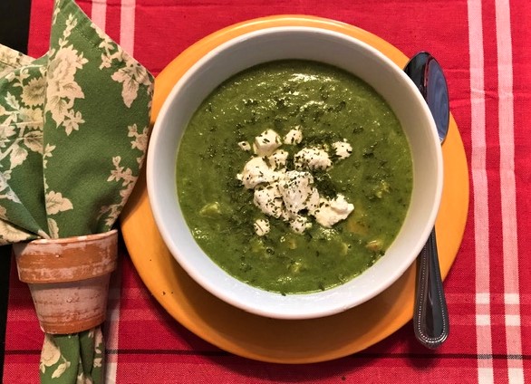 Plated bowl of Cream of Broccoli and Spinach Soup with Chicken and Goat cheese, thickened with avocado