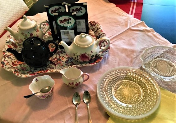 Tea Tasting Setup with teapots, plates and teas.