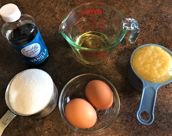 Wet ingredients for Applesauce Cranberry Quick Bread.  Vanilla, eggs, oil, applesauce, and sugar