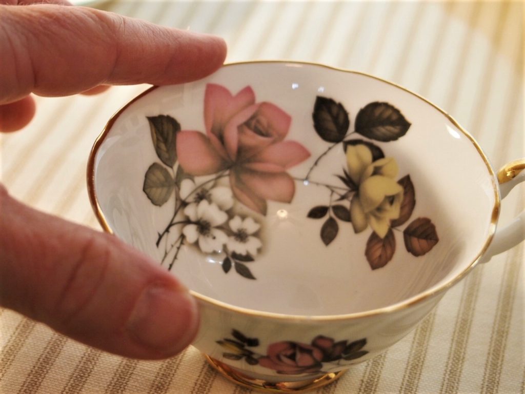 Tools for Vintage China Shopping - using your finger to find chips or roughness on china cup