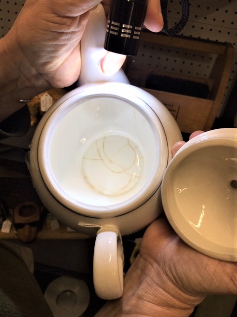 Tools for Vintage China Shopping - checking the cracks on the inside of teapot