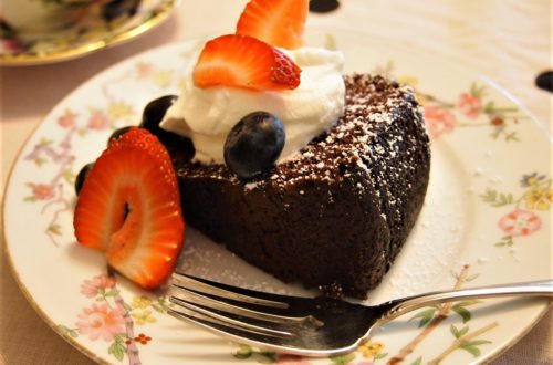 Single slice Wacky Cake with Whipped Cream and Fresh Fruit