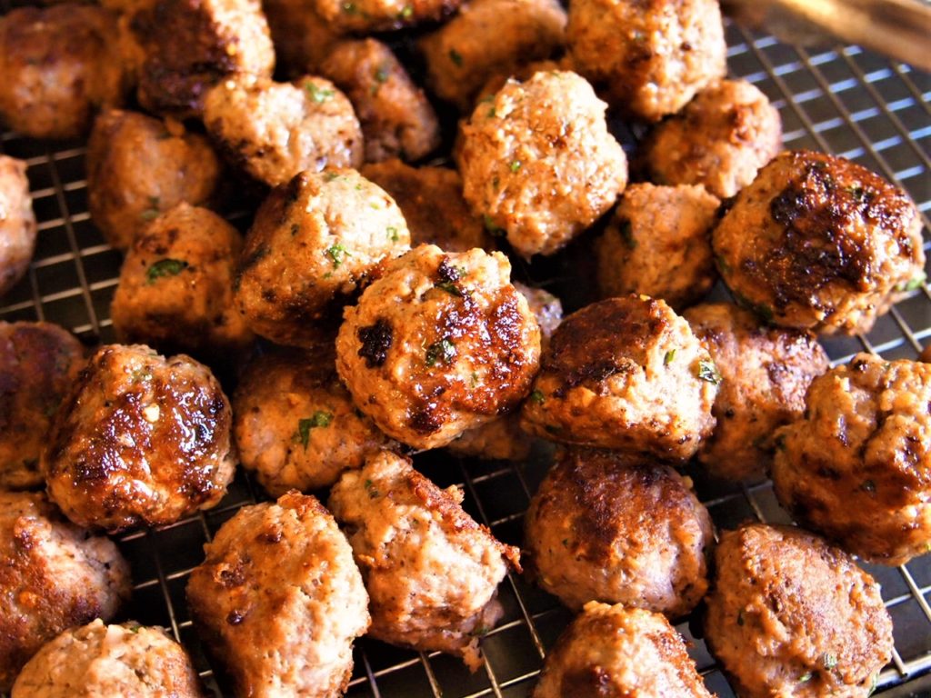 Masala Spice Tea Meatballs cooked and cooling on a rack.